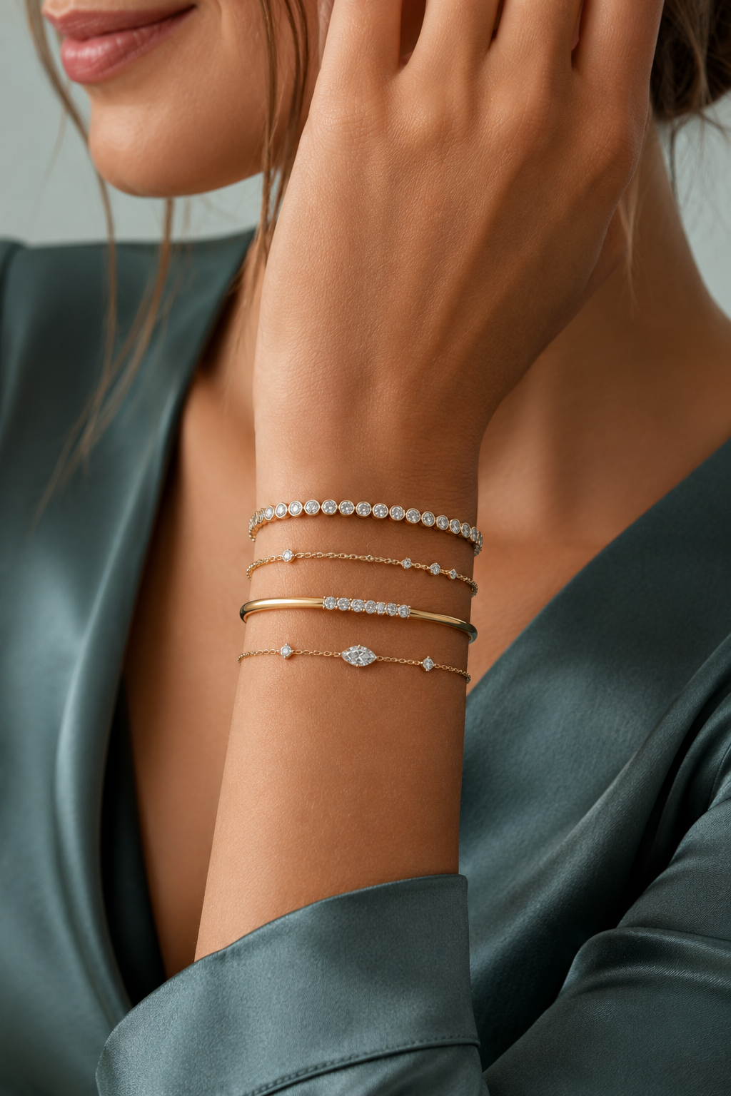 Stacked diamond and gold bracelets worn by a model